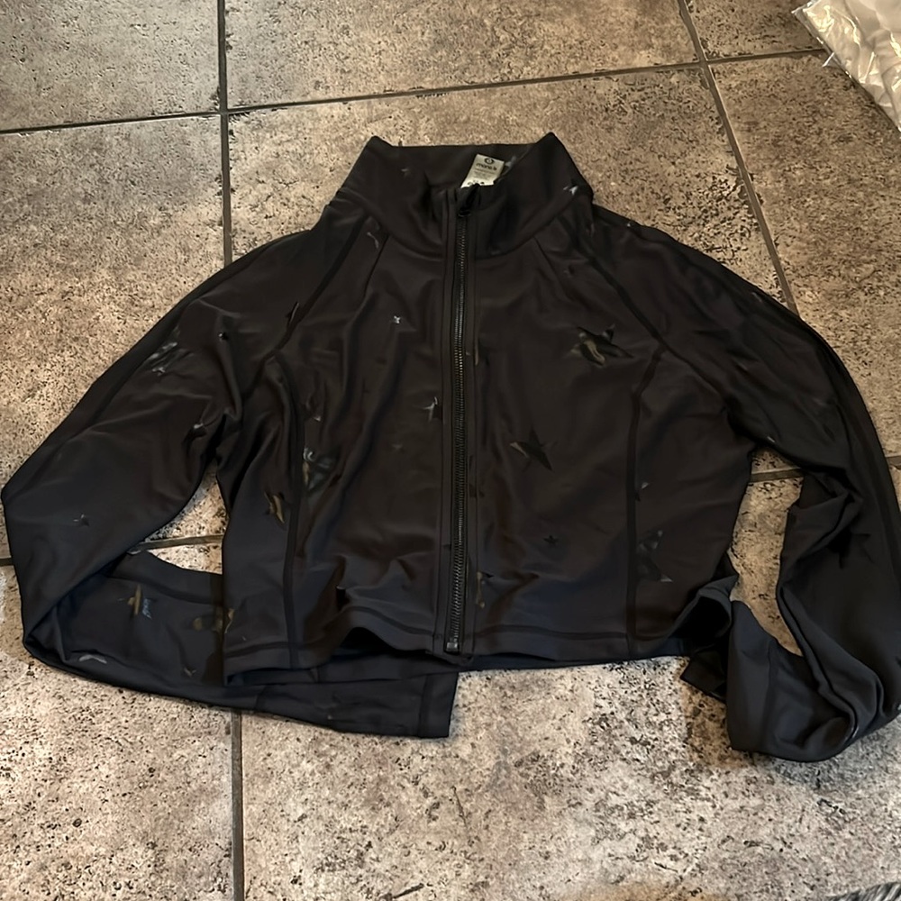 Black foil star long sleeve crop top with full zipper.